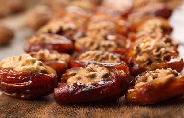 Walnut, date fruit on wooden table, close-up — Stock Photo, Image