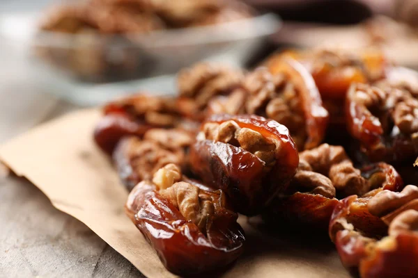 Walnut and date fruit on wooden table, close-up — Stock Photo, Image