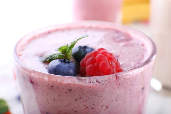 Milkshake with berries on light background, close-up — Stock Photo, Image