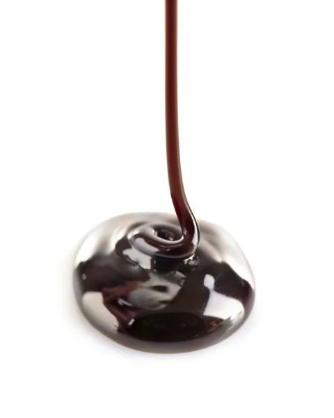 Melted black chocolate pouring, isolated on white — Stock Photo, Image