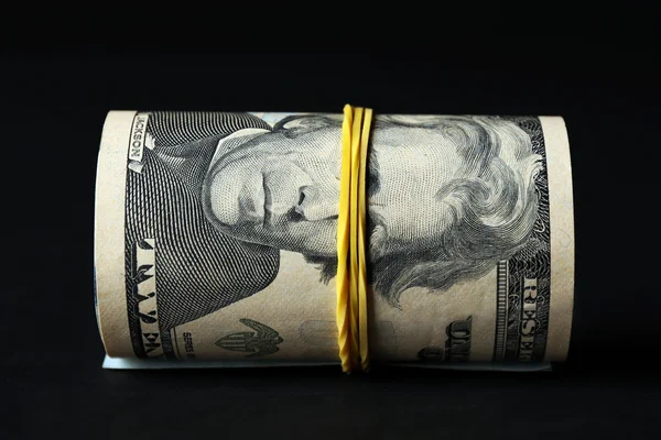Dollari rotolo su sfondo nero — Foto Stock