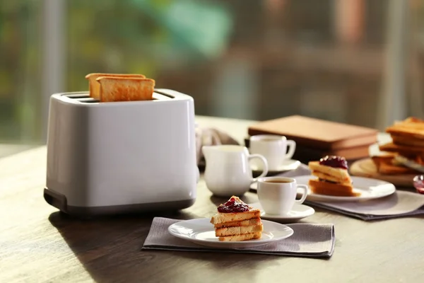 Served table for breakfast with toast and coffee, on blurred background — Stock Photo, Image