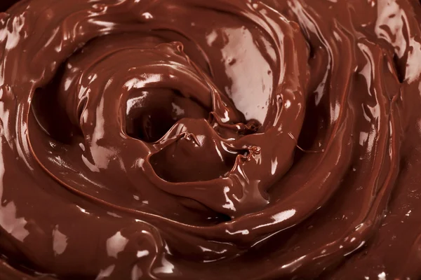 Hintergrund geschmolzene Milchschokolade, Nahaufnahme — Stockfoto