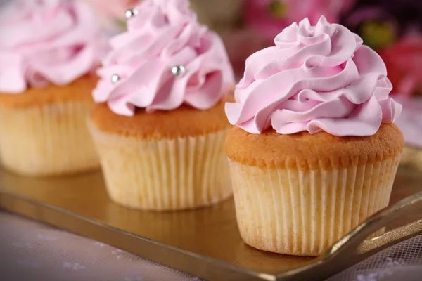 Tasty cupcakes on light background — Stock Photo, Image