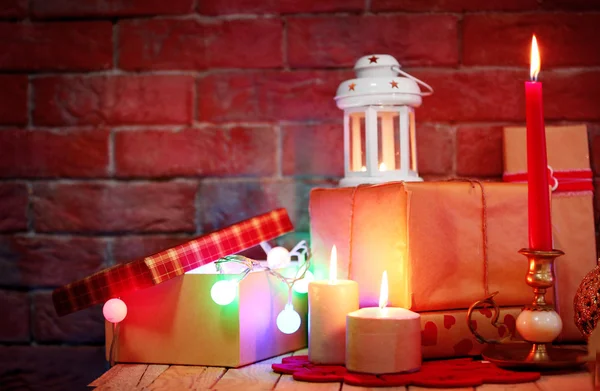 Beautiful candles on decorated wooden table, close up — Stock Photo, Image