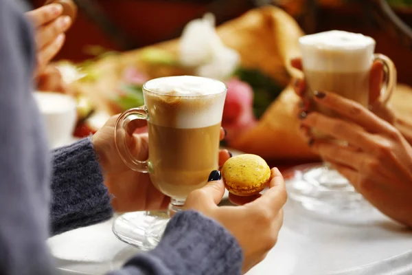 Women meeting in cafe and drinking latte