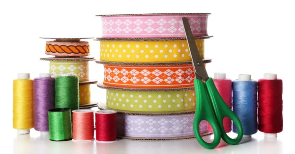 Spools of color ribbon, scissors and thread, isolated on white — Stock Photo, Image