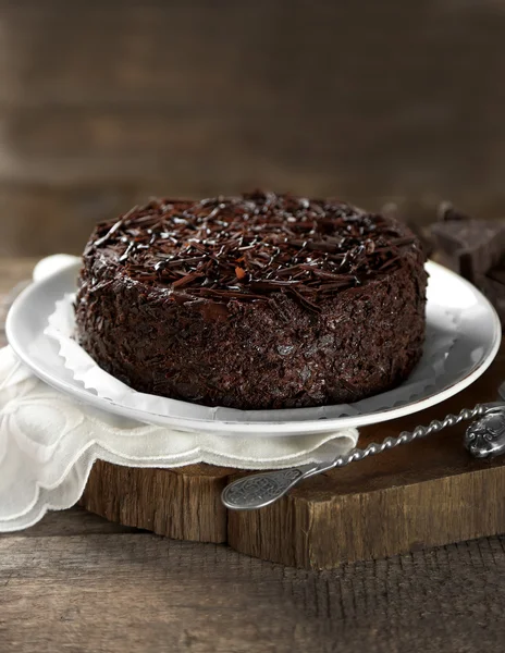 Tasty chocolate cake on wooden background — Stock Photo, Image