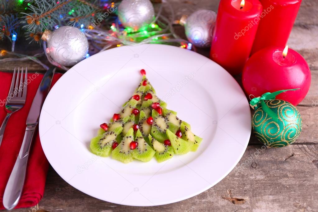 Christmas fir tree made from kiwi, on plate, close up