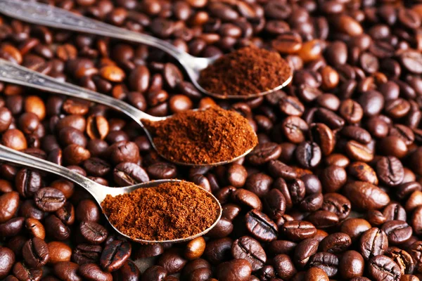 Spoons with coffee on coffee beans — Stock Photo, Image