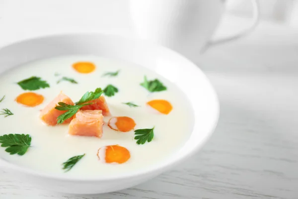 Delicious cream soup with salmon and carrot in white bowl — Stock Photo, Image