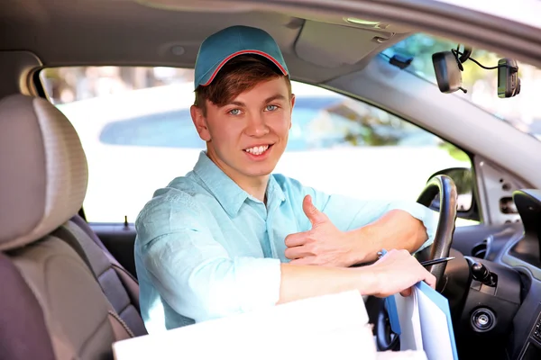 Pizza delivery boy in car, close-up — Stock Photo, Image