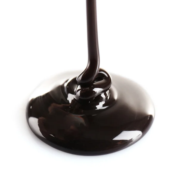 Melted black chocolate pouring, isolated on white — Stock Photo, Image