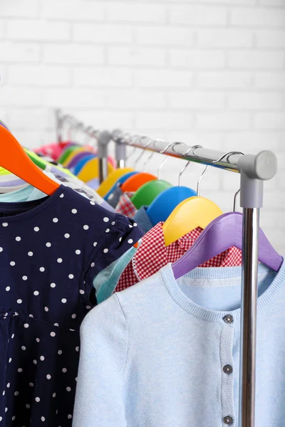 Children clothes on hangers — Stock Photo, Image