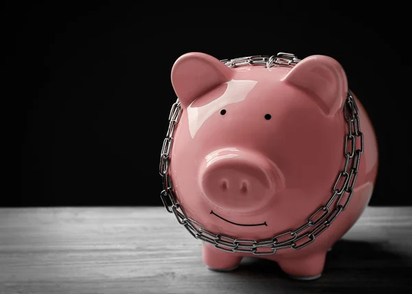 Piggy bank and chains — Stock Photo, Image