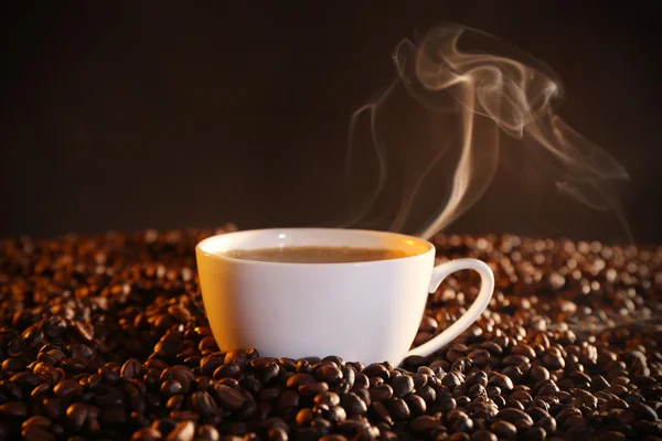 Cup of hot coffee and coffee beans closeup Stock Picture