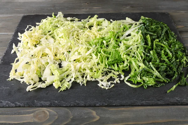 Cut savoy cabbage on wooden background — Stock Photo, Image