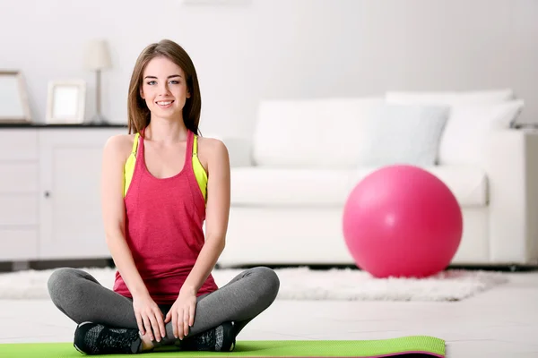 Hermosa chica joven con la bola en forma en casa — Foto de Stock