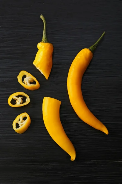Sárga chili paprika, sötét fából készült háttér — Stock Fotó