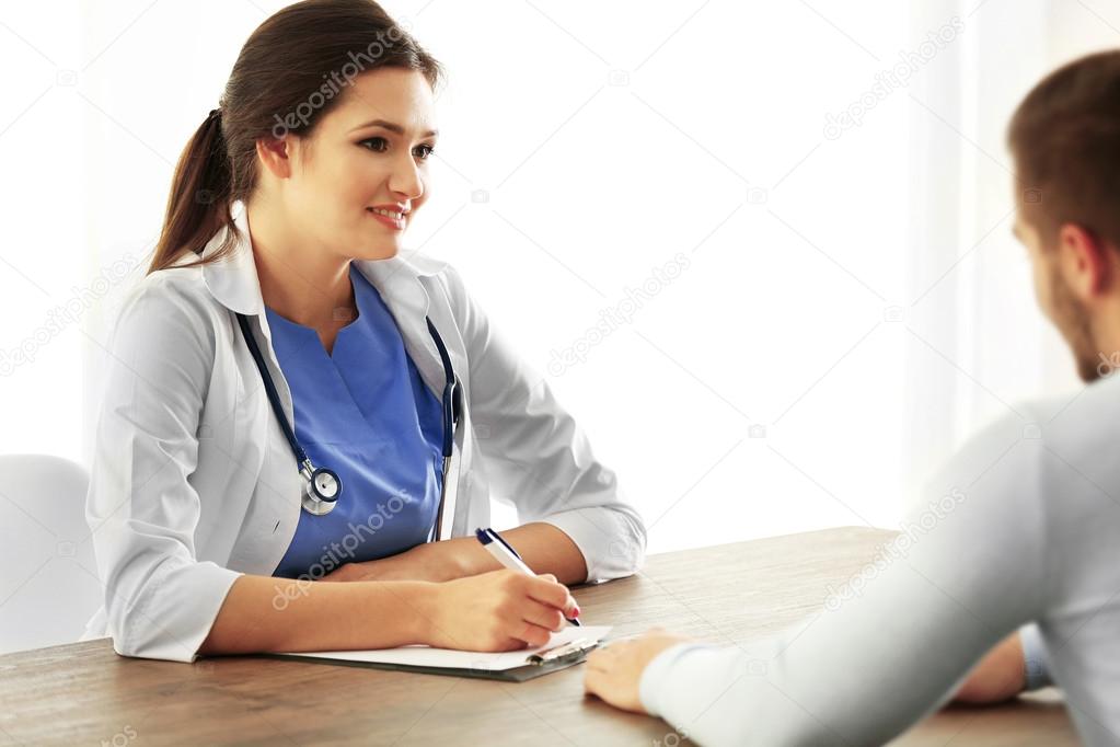 Doctor talking to male patient