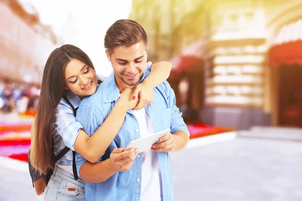 Happy couple with tablet