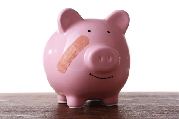 Piggy bank met zelfklevend verband — Stockfoto