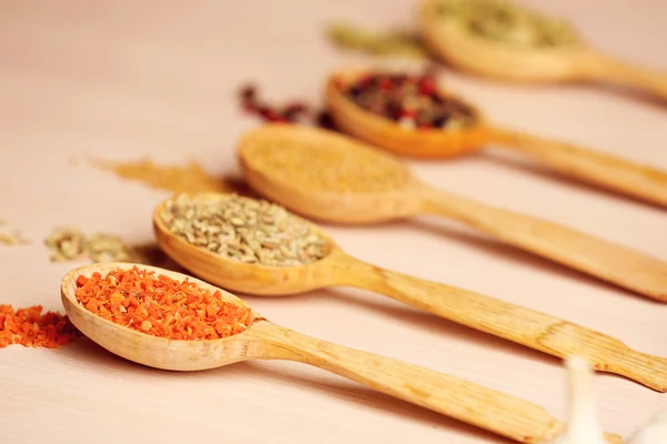 Variety of spices in spoons on the kitchen table — Stock Photo, Image