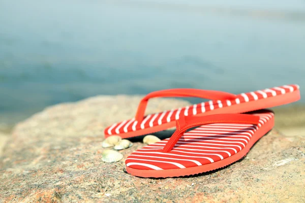 Bright flip-flops on stone — Stock Photo, Image