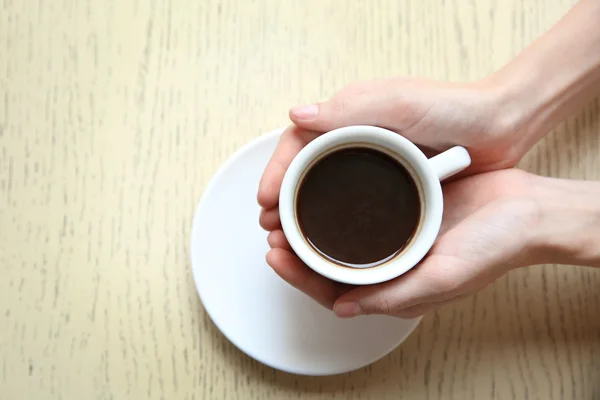 Cup of coffee with hands — Stock Photo, Image