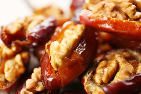 Walnut and date fruit on wooden table, close-up — Stock Photo, Image