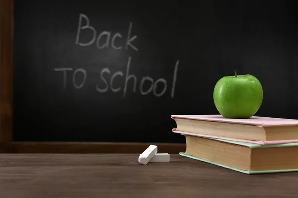 Apple and books on desk background