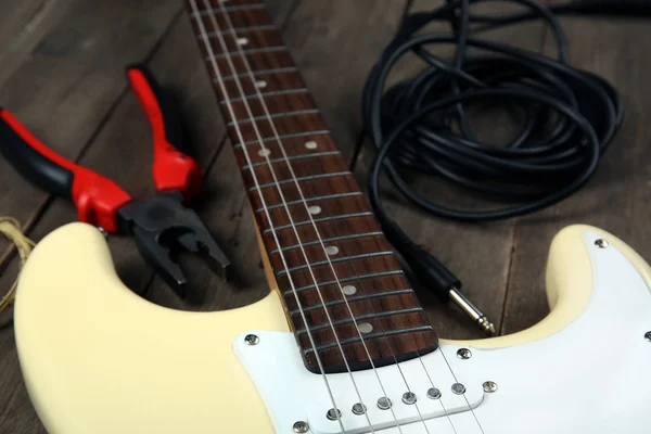 Electric guitar with pliers — Stock Photo, Image