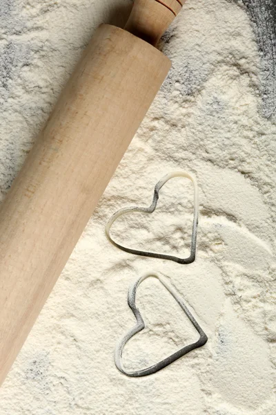 Hearts of flour and rolling pin — Stock Photo, Image