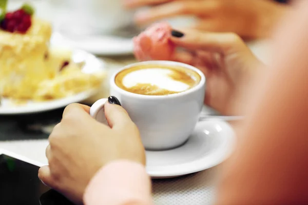 Mujer con una taza de café y pastel en la cafetería — Foto de Stock