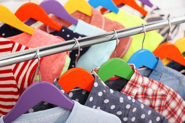 Clothes for children on hangers closeup — Stock Photo, Image