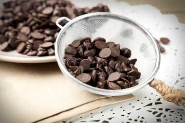 Çikolata morsels ahşap tahta üzerinde plaka üzerinde