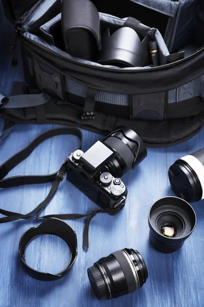 Photographer's equipment on a dark blue wooden background — Stock Photo, Image