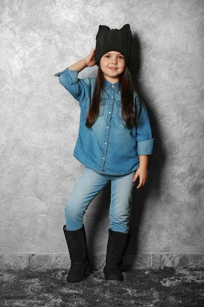 Portrait of little fashion kid girl on gray wall background — Stock Photo, Image