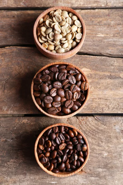 Collection of coffee beans on old wooden table, close up — Stock Photo, Image