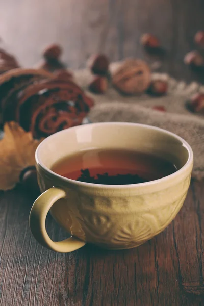 木製テーブルの上の秋の装飾が施されたお茶のカップ. — ストック写真