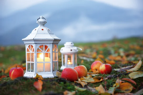 Lanterns with candles on grass — Stock Photo, Image