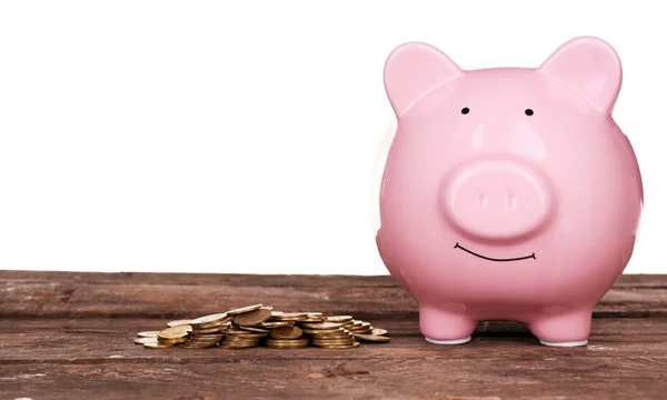 Piggy bank and pile of coins — Stock Photo, Image