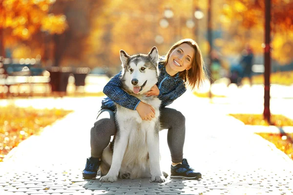 Vrouw wandelen met hond in park — Stockfoto