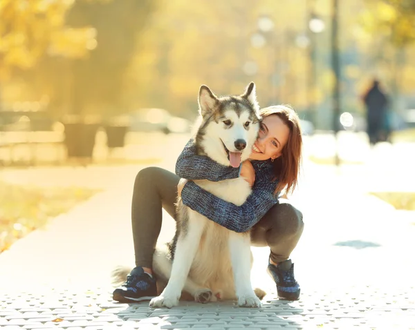 Kvinna promenader med hund i parken — Stockfoto