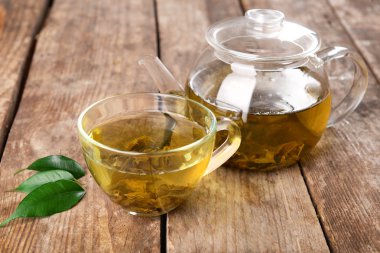 Cam bardak çay ve çaydanlık ahşap arka plan üzerinde