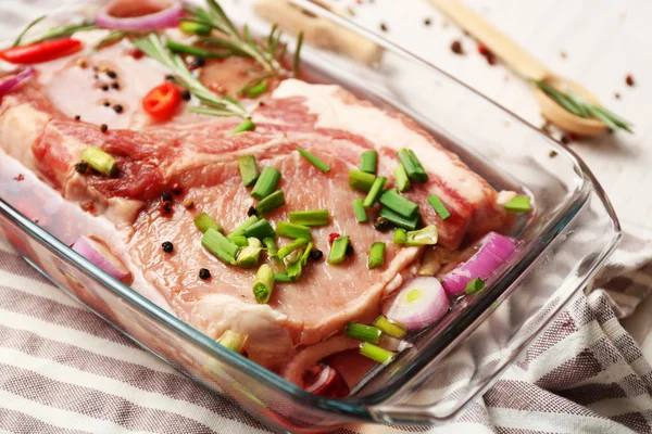 Marinating meat with spices on table, close up — Stock Photo, Image