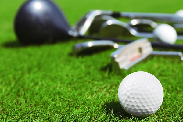 Diferentes tacos de golfe e bolas no campo de golfe, close-up — Fotografia de Stock
