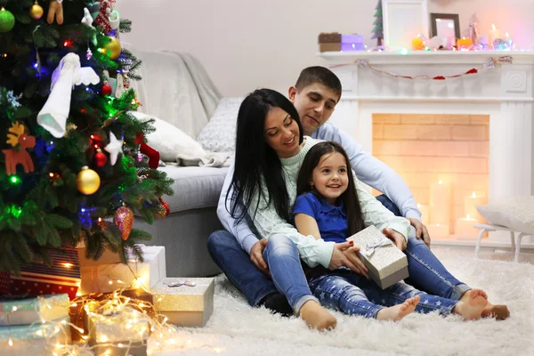 Happy family on floor with gifts — Stock Photo, Image