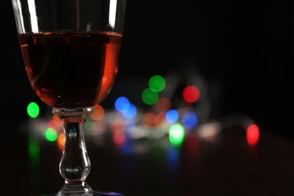 Wine glass with bokeh on dark background — Stock Photo, Image