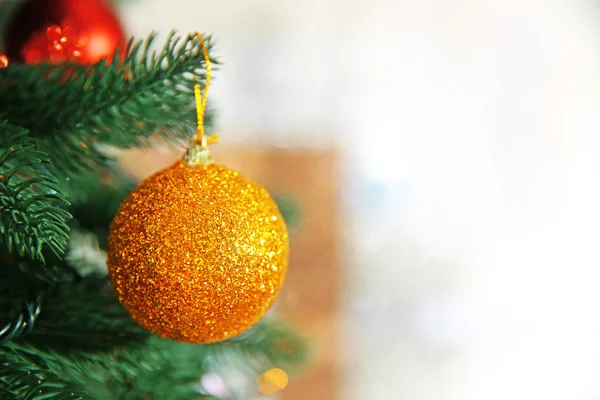 Christmas golden bauble on a fir tree — Stock Photo, Image